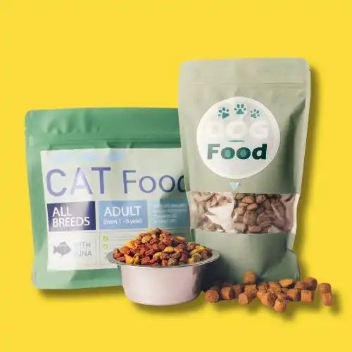 Cat food packages and a bowl of dry kibble.